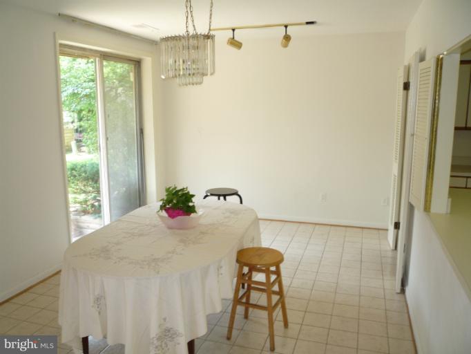 6 Cross Keys Road, Unit 6A Baltimore, MD 21210 - Photo 4 of 30 a bedroom with a bed and a chandelier
