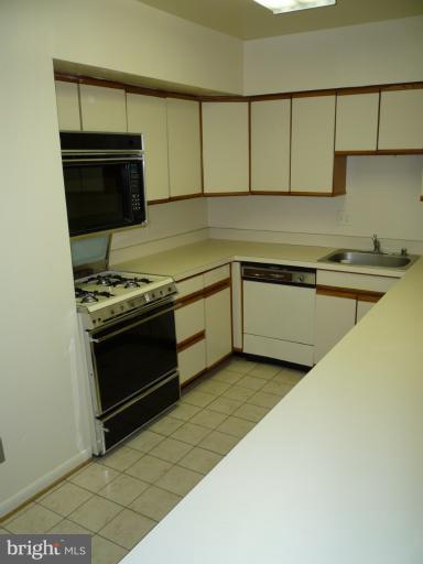 6 Cross Keys Road, Unit 6A Baltimore, MD 21210 - Photo 5 of 30 a kitchen with stainless steel appliances a stove and a microwave