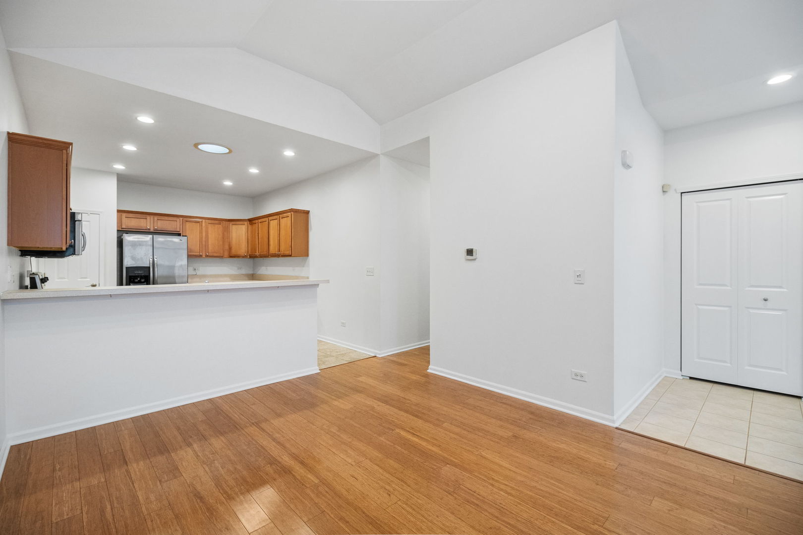 23908 Dayfield Drive, Unit 23908 Plainfield, IL 60586 - Photo 12 of 23 a view of an empty room with wooden floor and a window