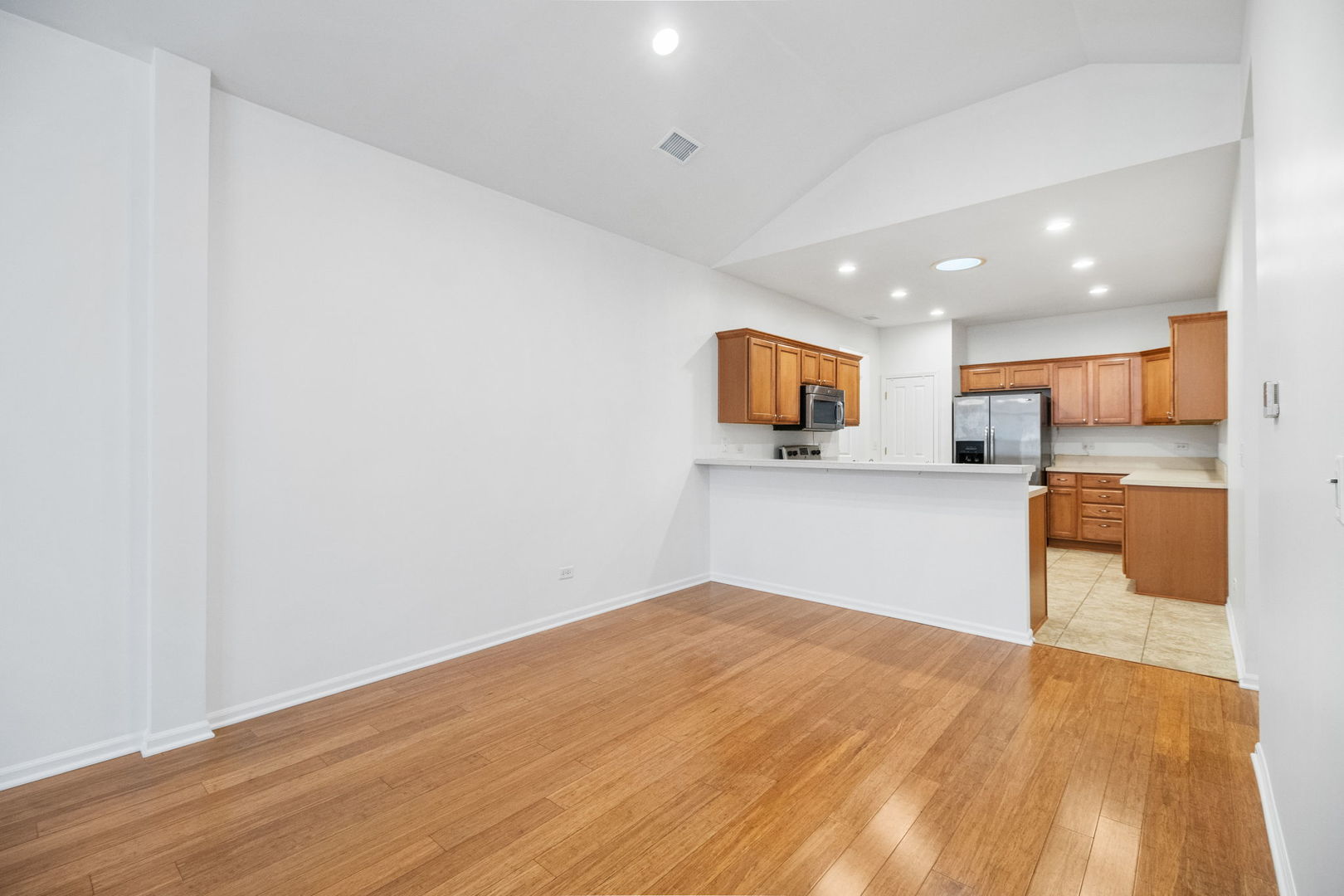 23908 Dayfield Drive, Unit 23908 Plainfield, IL 60586 - Photo 13 of 23 a view of a kitchen with wooden floor