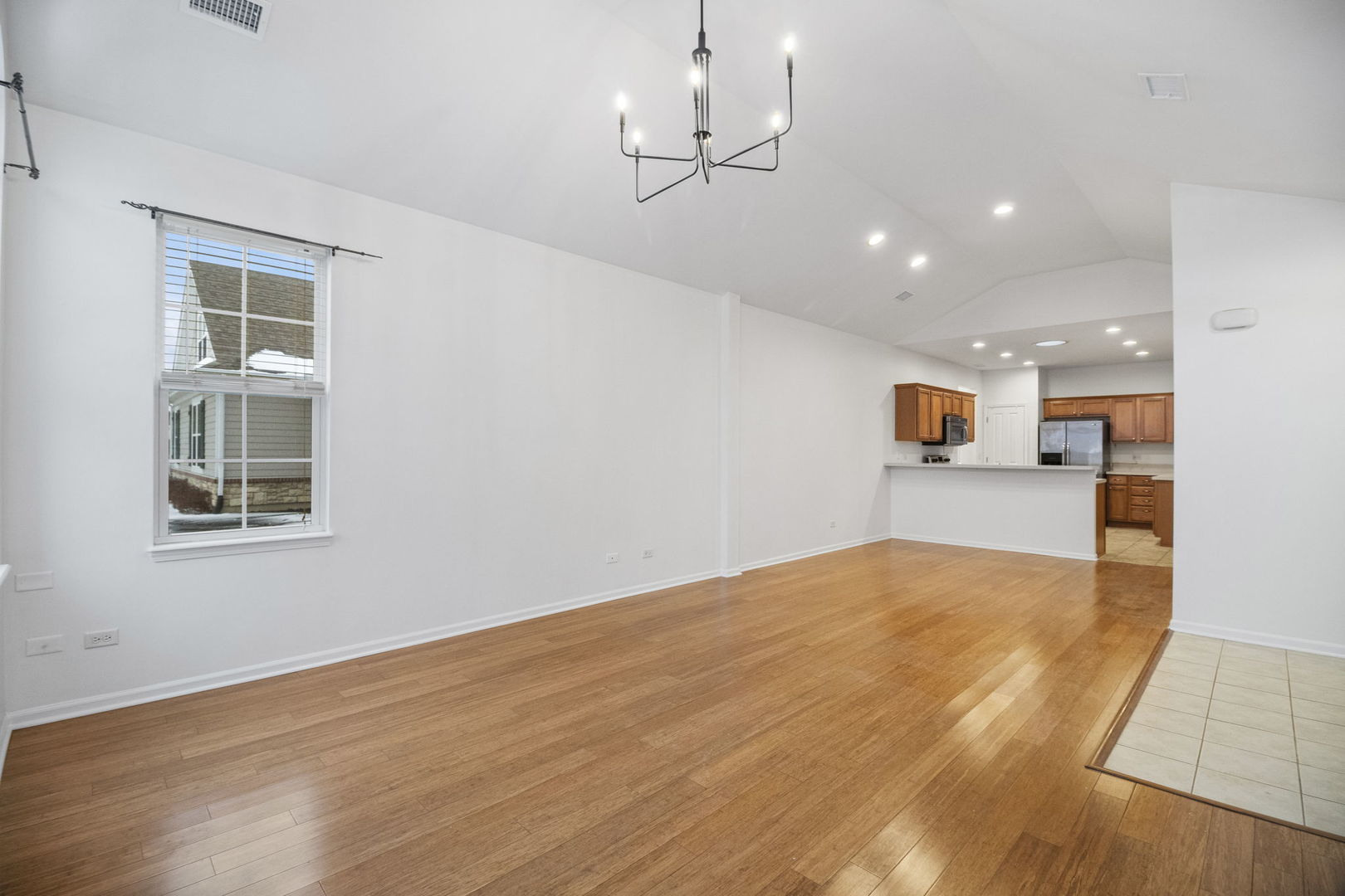 23908 Dayfield Drive, Unit 23908 Plainfield, IL 60586 - Photo 5 of 23 a view of empty room with wooden floor and windows