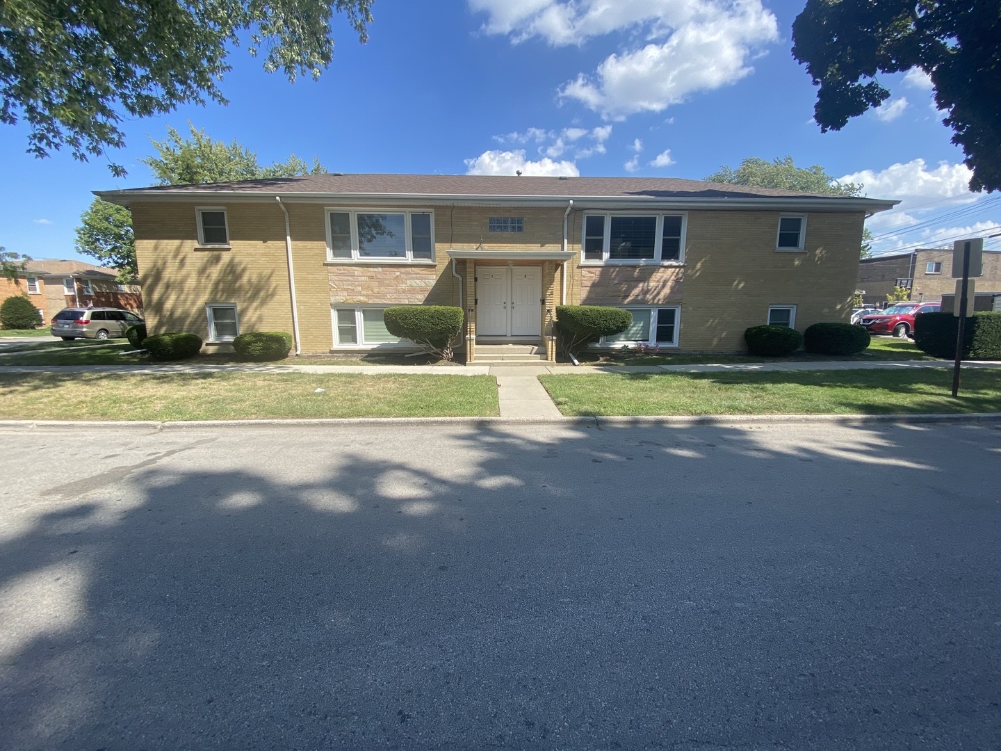 a front view of house with yard and green space