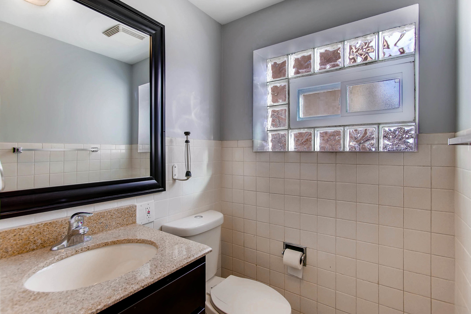 7233 38th Place Lyons, IL 60534 - Photo 11 of 26 a bathroom with a sink toilet and mirror