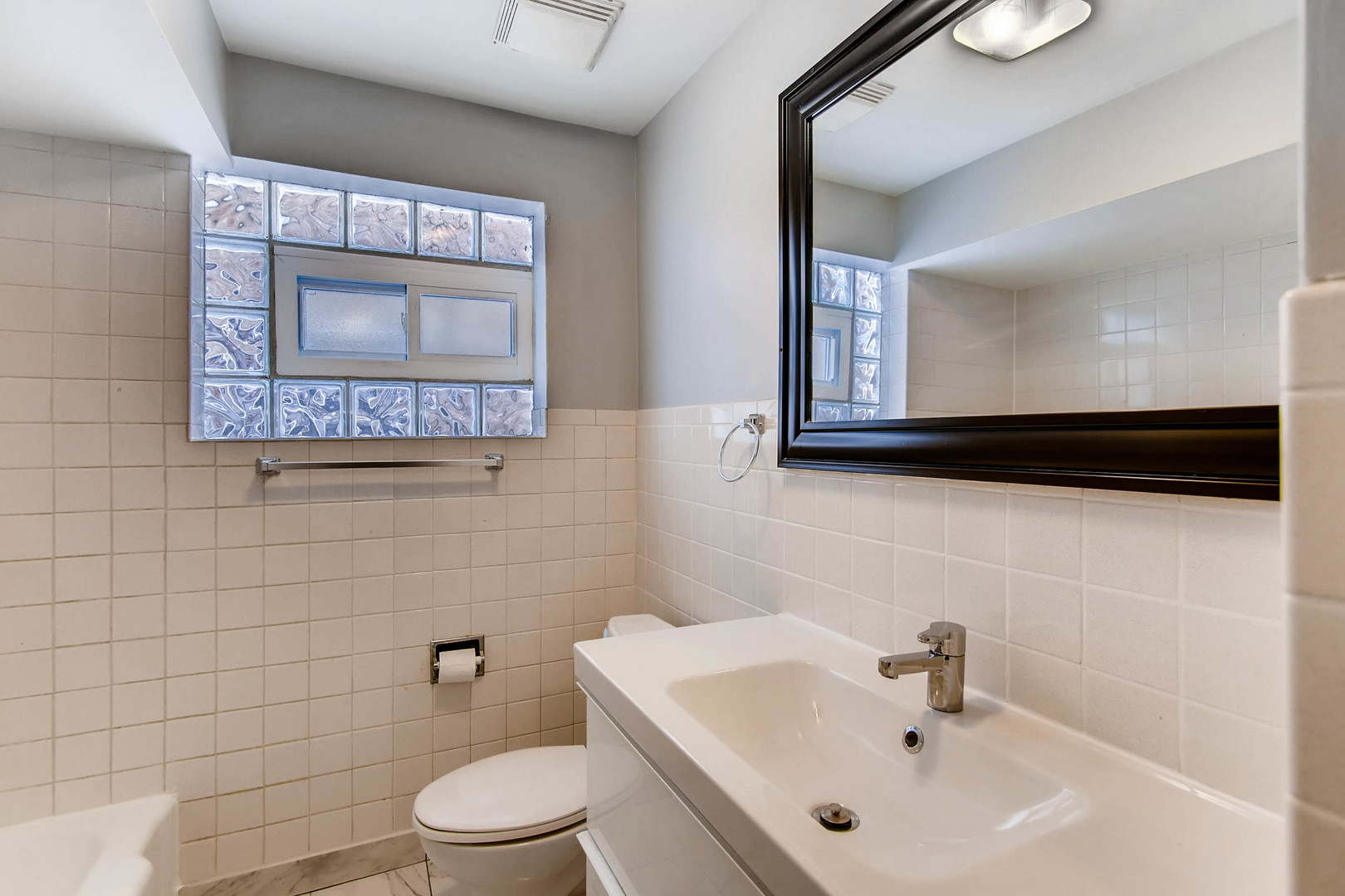 7233 38th Place Lyons, IL 60534 - Photo 12 of 26 a bathroom with a toilet sink and mirror