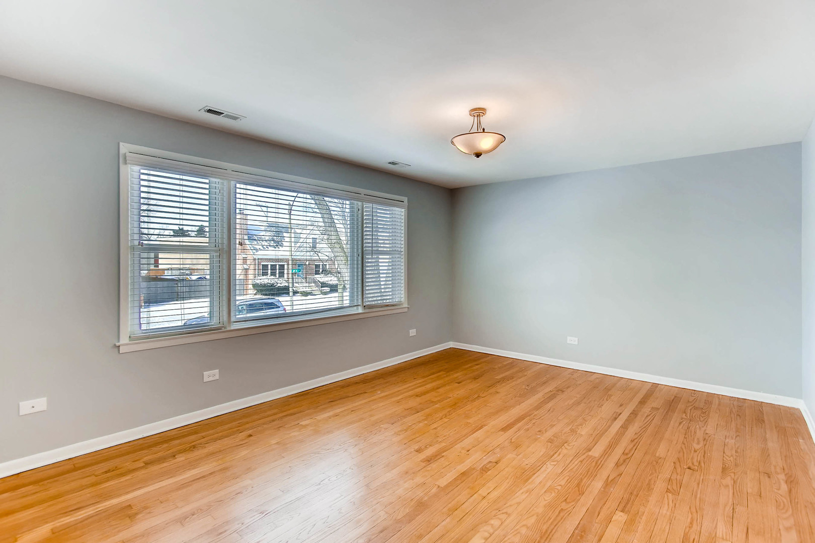 7233 38th Place Lyons, IL 60534 - Photo 15 of 26 wooden floor in an empty room with a window