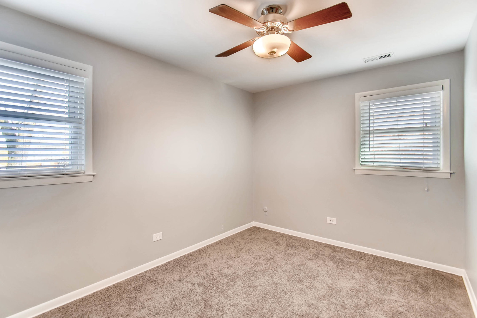 7233 38th Place Lyons, IL 60534 - Photo 20 of 26 an empty room with a window and a fan
