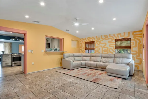 a bathroom with a toilet sink vanity and window