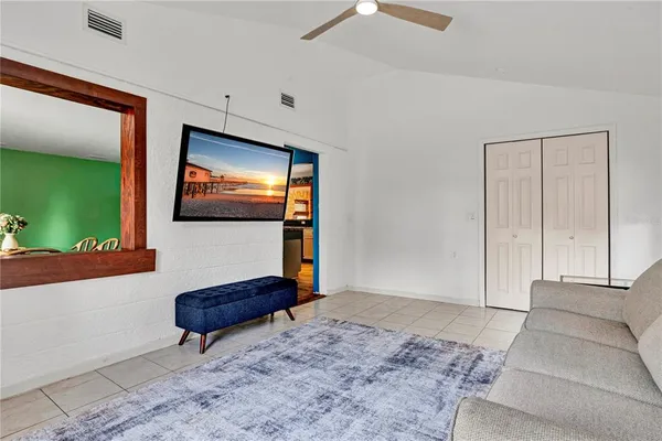 an empty room with cabinet and windows