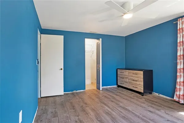 a view of a room with a fan and a large window