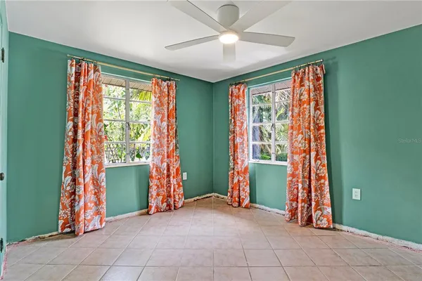 a view of an empty room with closet and a window