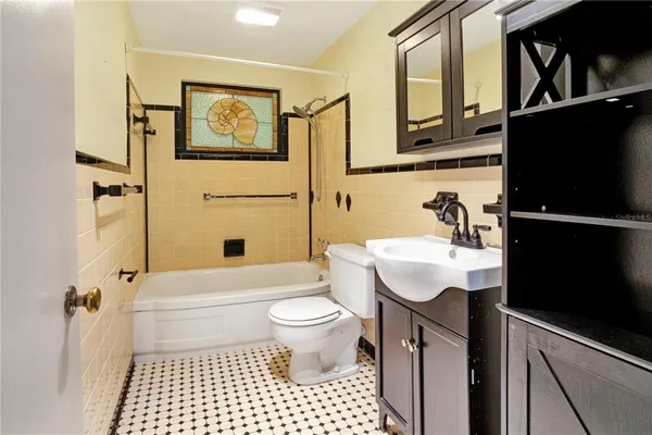 a view of a house with large windows and a tree