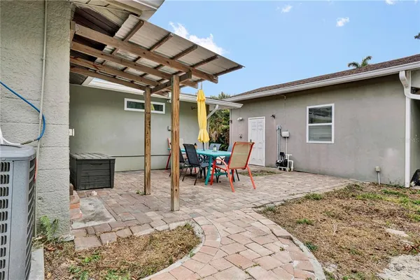 a view of a house with a backyard and a porch