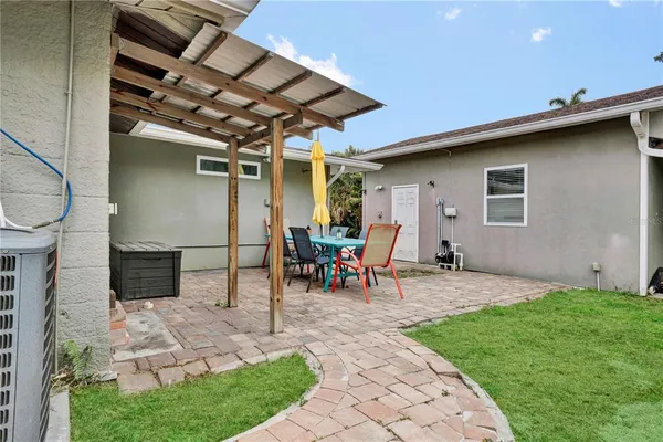 a view of a house with a backyard and a garden