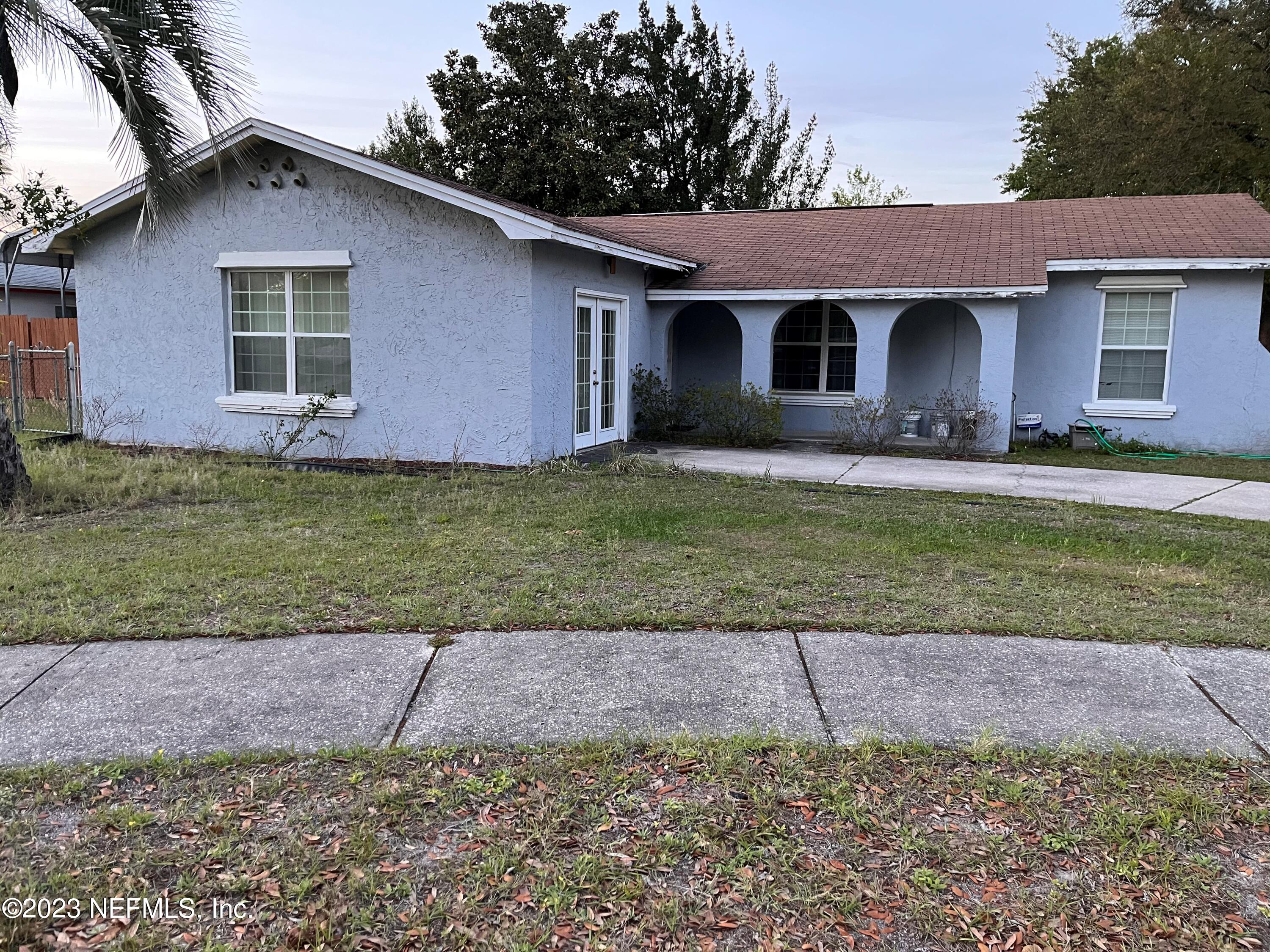 8345 Chessman Court Jacksonville, FL 32244 - Photo 1 of 6 a front view of a house with a garden