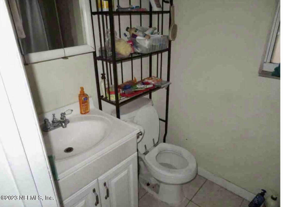 8345 Chessman Court Jacksonville, FL 32244 - Photo 6 of 6 a bathroom with a sink toilet and vanity