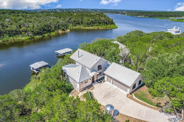 an aerial view of a house with garden space and lake view