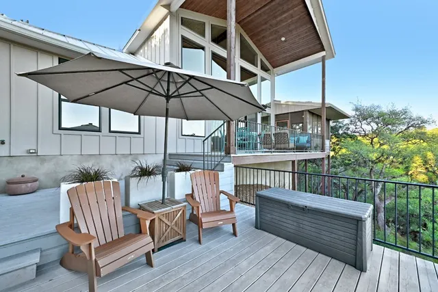 a view of a roof deck with chair and wooden floor