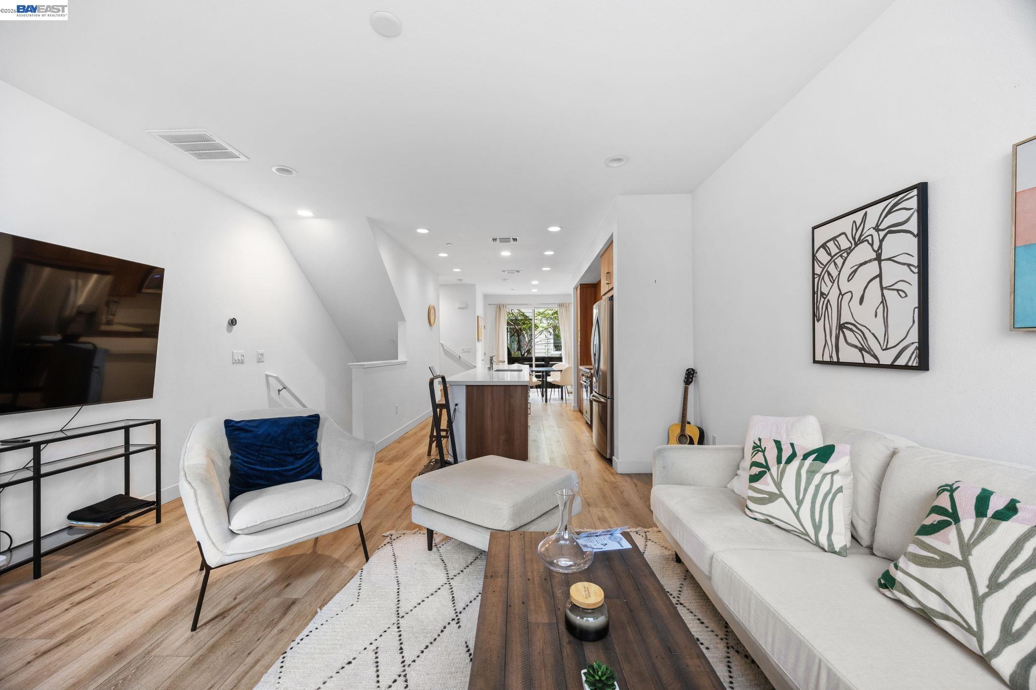 117 Uptown Circle Oakland, CA 94607 - Photo 3 of 7 a living room with furniture and a flat screen tv