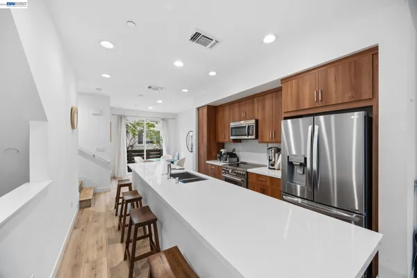 a kitchen with sink refrigerator and microwave