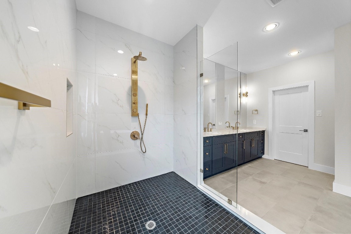 2200 Marnel Road, Unit I Houston, TX 77055 - Photo 13 of 25 a bathroom with a double vanity sink a mirror and shower