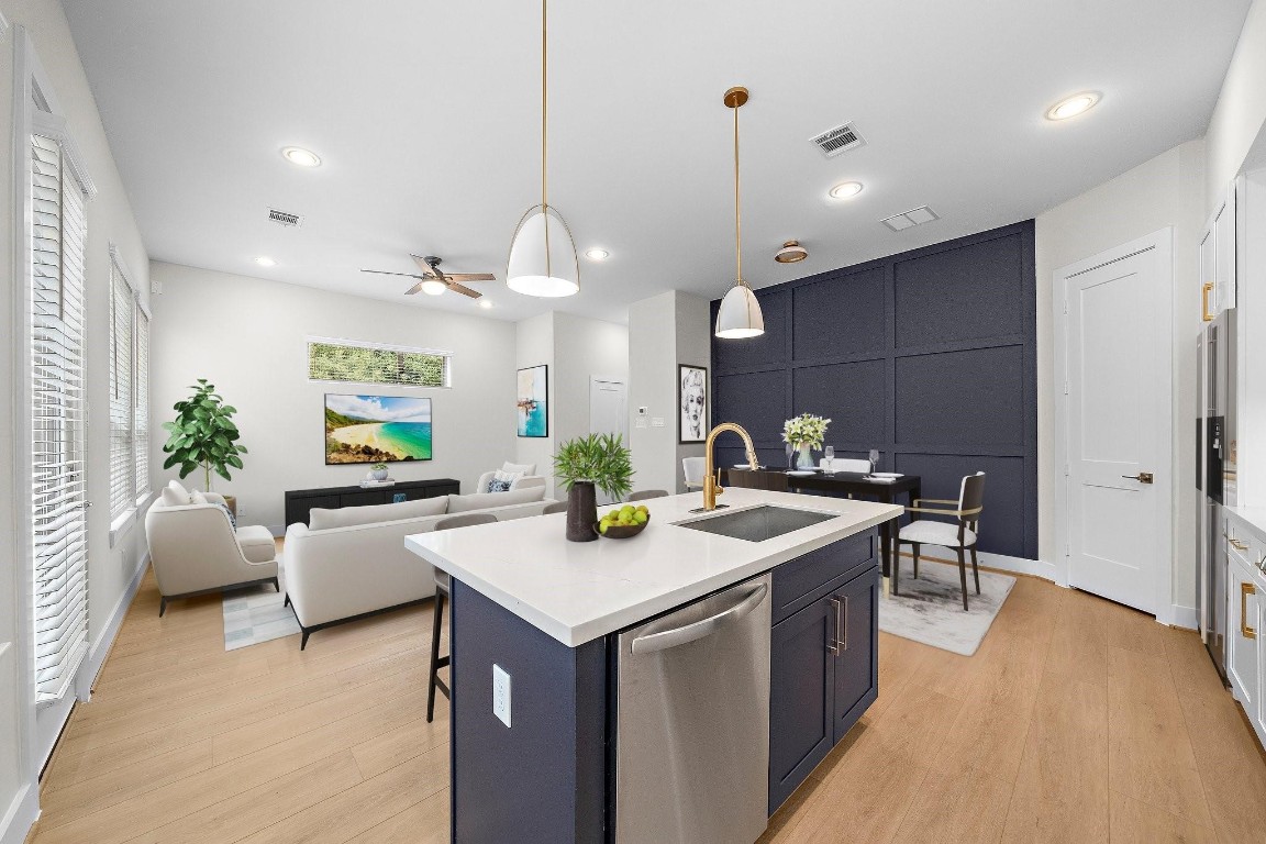 2200 Marnel Road, Unit I Houston, TX 77055 - Photo 7 of 25 a kitchen with kitchen island a sink a counter top space and living room view