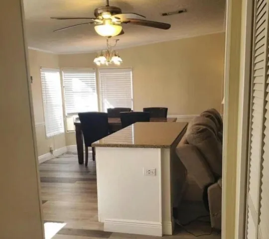 a view of a dining room with furniture wooden floor and chandelier