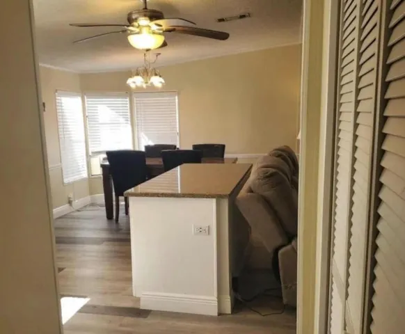 a view of dining room and chandelier fan