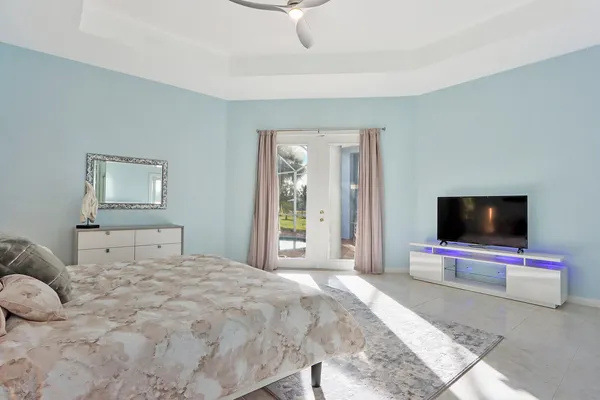 a bedroom with a bed and a flat screen tv