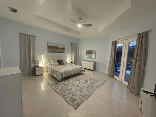 a bedroom with a large bed and a couch