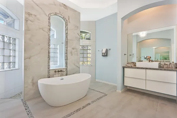 a spacious bathroom with a bathtub and mirror