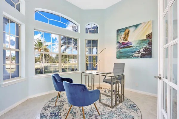 a view of a dining room with furniture a rug and wooden floor