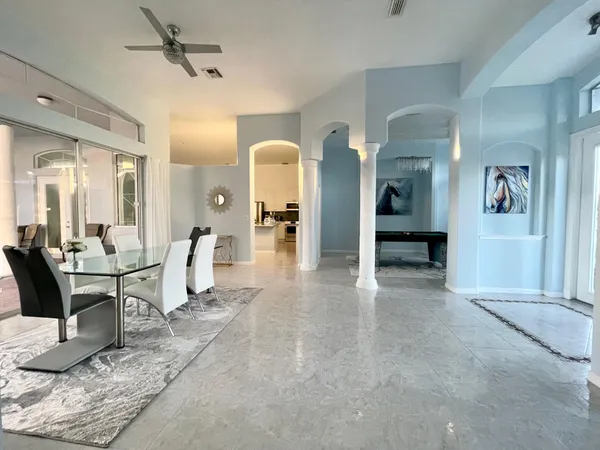 a room with pool table and windows