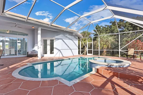 a view of a swimming pool with outdoor seating