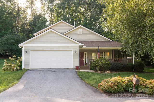 a view of a house with yard and a garden