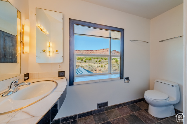 6178 East Zion Road Kanab, UT 84741 - Photo 36 of 48 Bathroom featuring vanity, a mountain view, and stone finish flooring