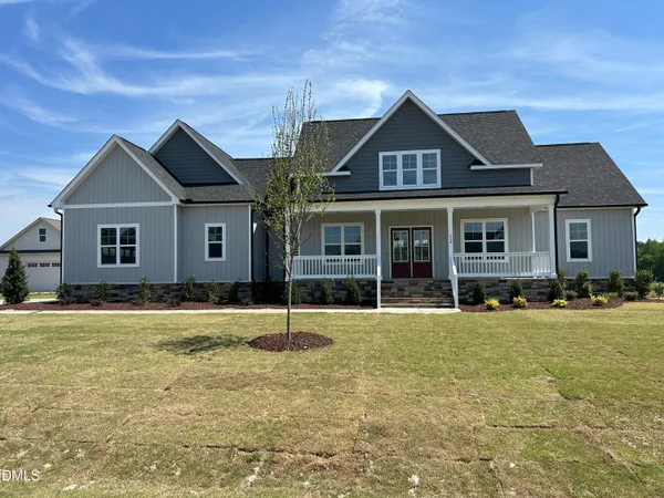 a large kitchen with stainless steel appliances kitchen island granite countertop a large cabinets a sink and a stove