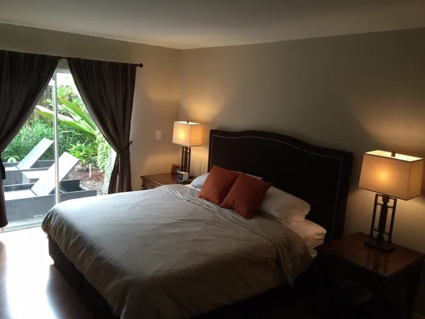 a bedroom with a bed and a lamp