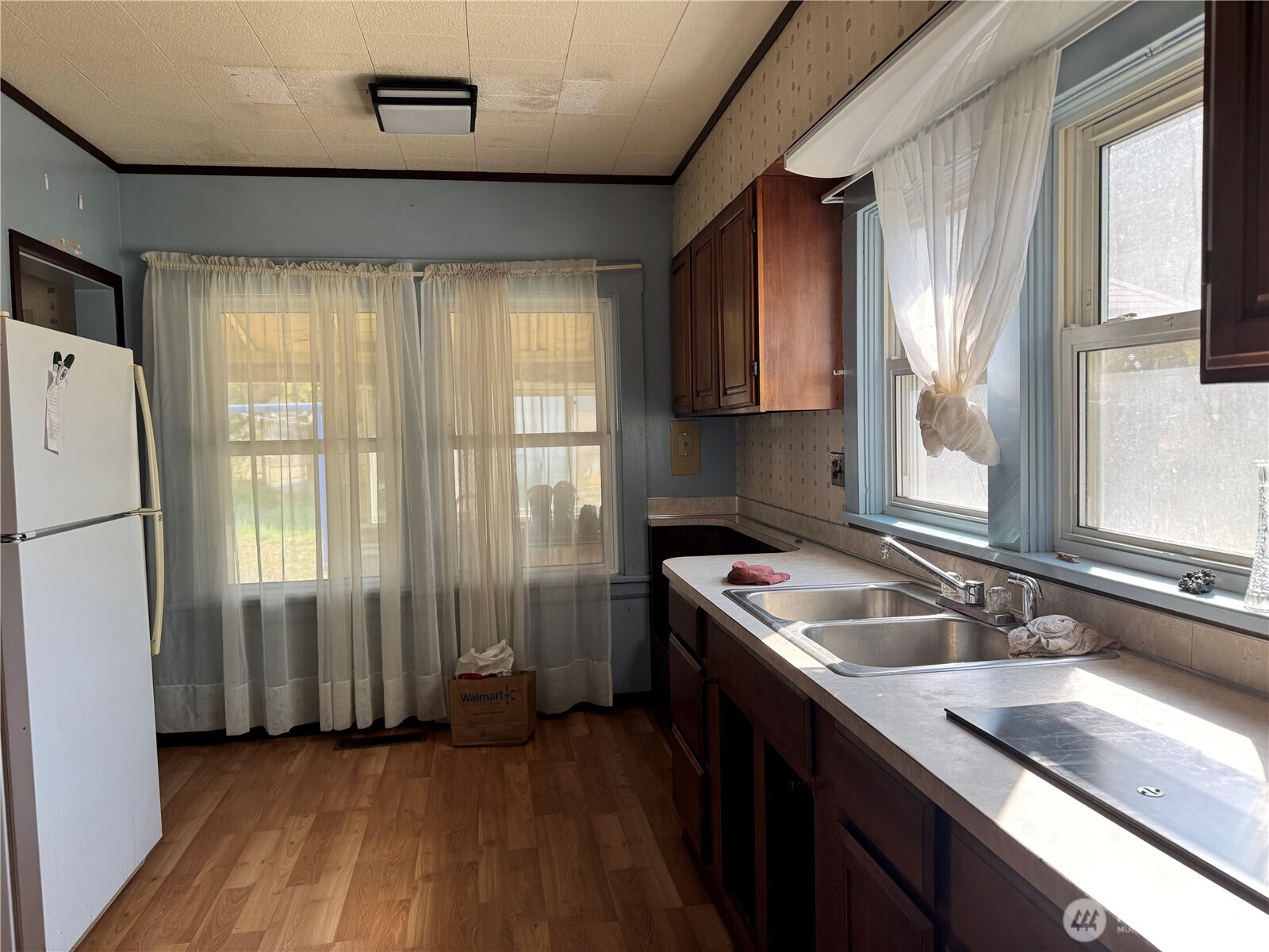 8 South Main Street Curlew, WA 99118 - Photo 14 of 25 a kitchen with a sink a refrigerator a window and cabinets