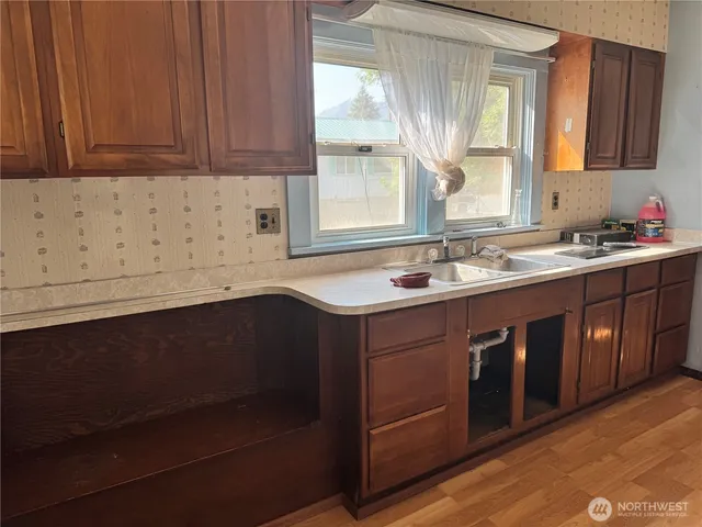 a kitchen with a sink dishwasher and cabinets