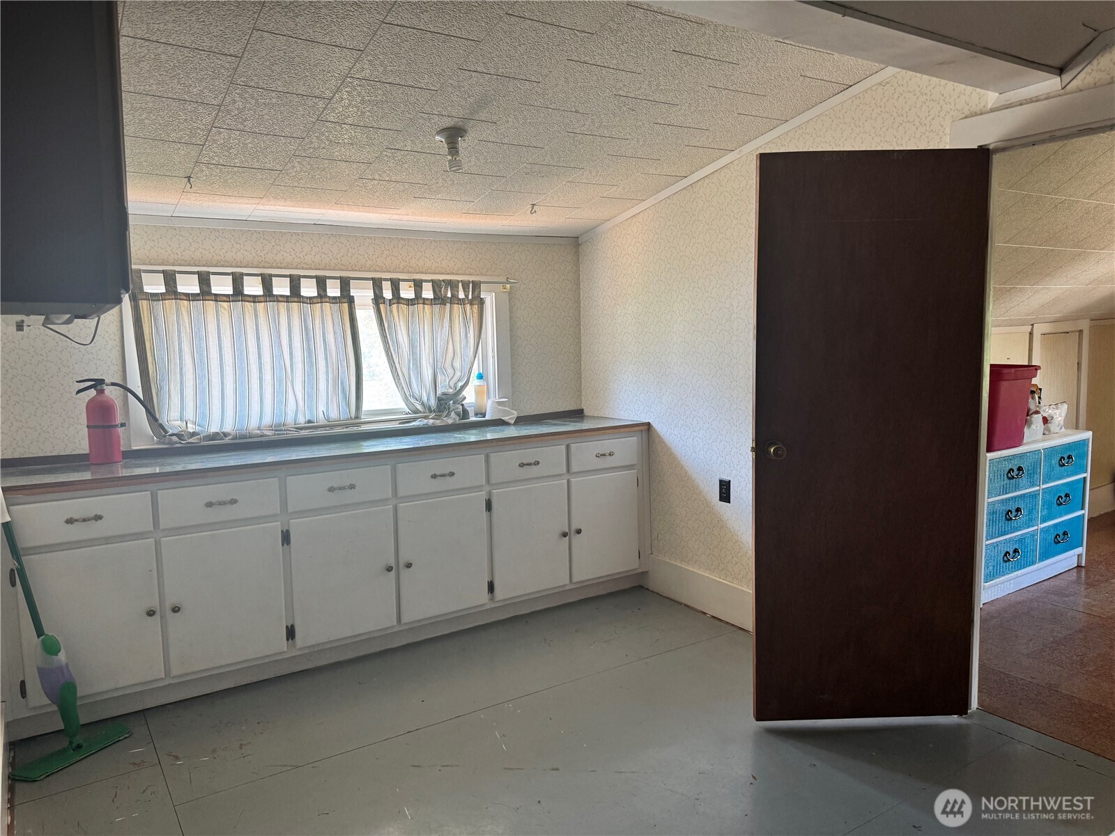 8 South Main Street Curlew, WA 99118 - Photo 4 of 25 a kitchen with white cabinets and a sink