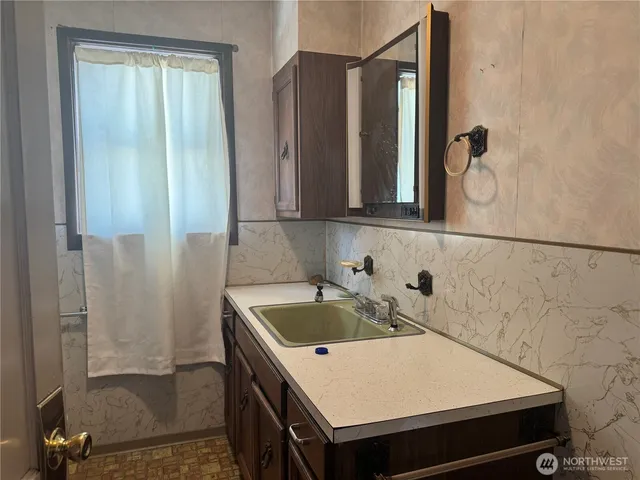 a bathroom with a sink and a mirror