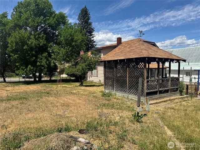 a backyard of a house with table and chairs
