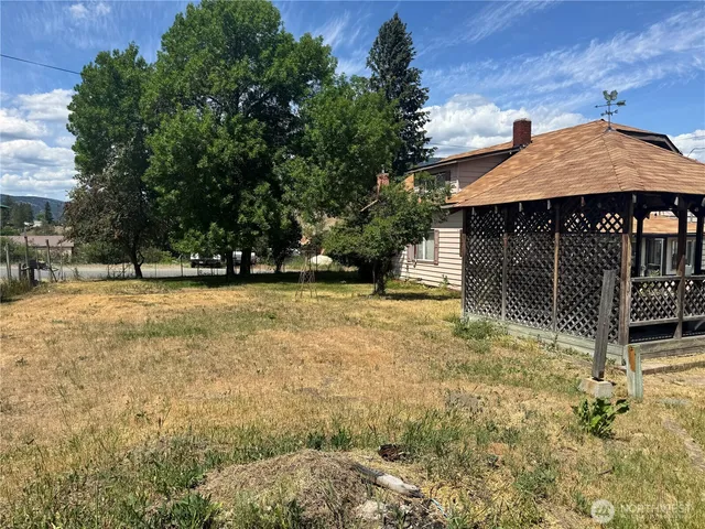 a backyard of a house with barbeque oven