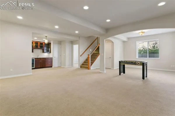an empty room with furniture and a ceiling fan