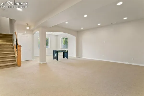 an empty room with large windows