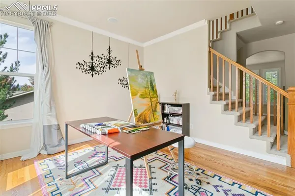 a view of a hallway with furniture and paintings on the wall