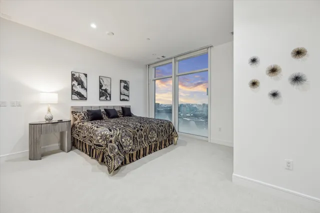 a bedroom with furniture and a large window