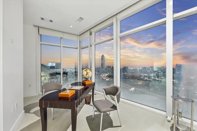 a view of a very nice looking dining room with a table and chairs