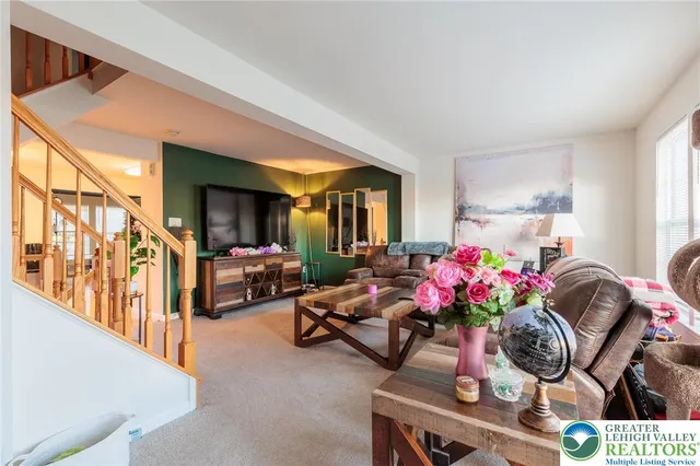 a living room with furniture chess table and a potted plant