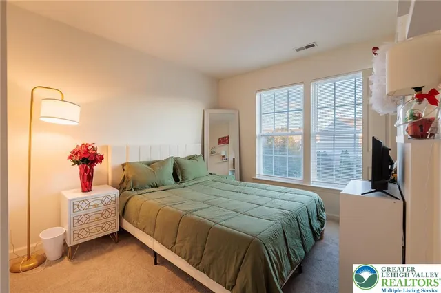 a bedroom with furniture and a window